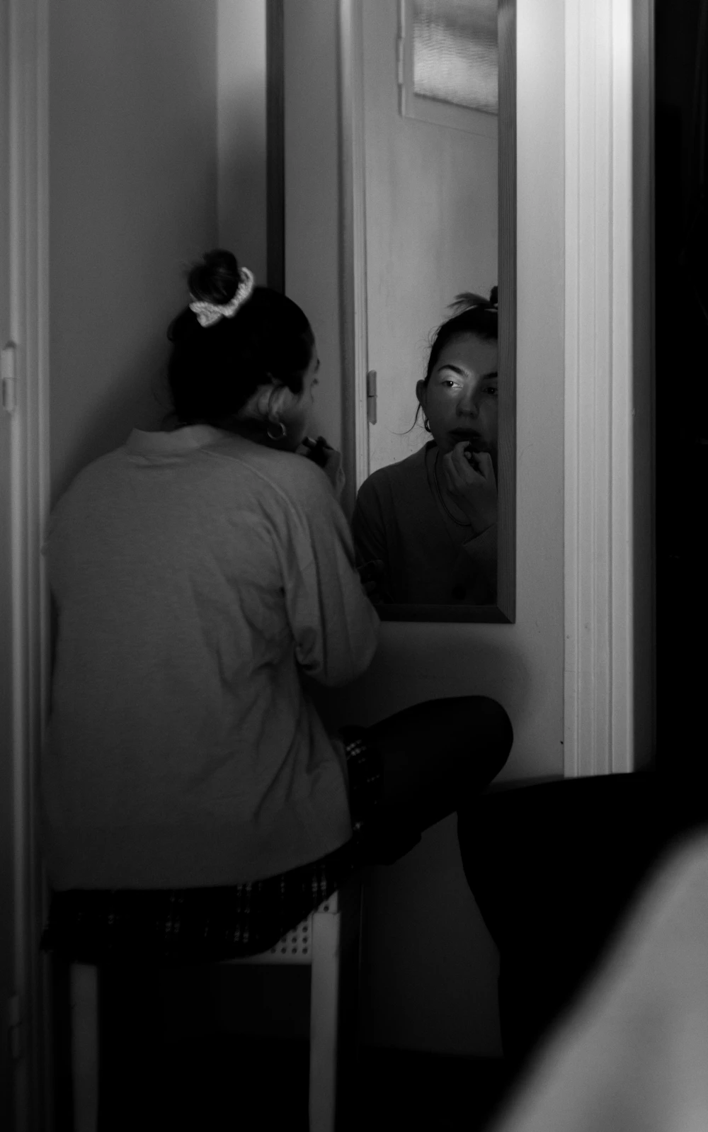 Woman applying luxury makeup in front of a mirror